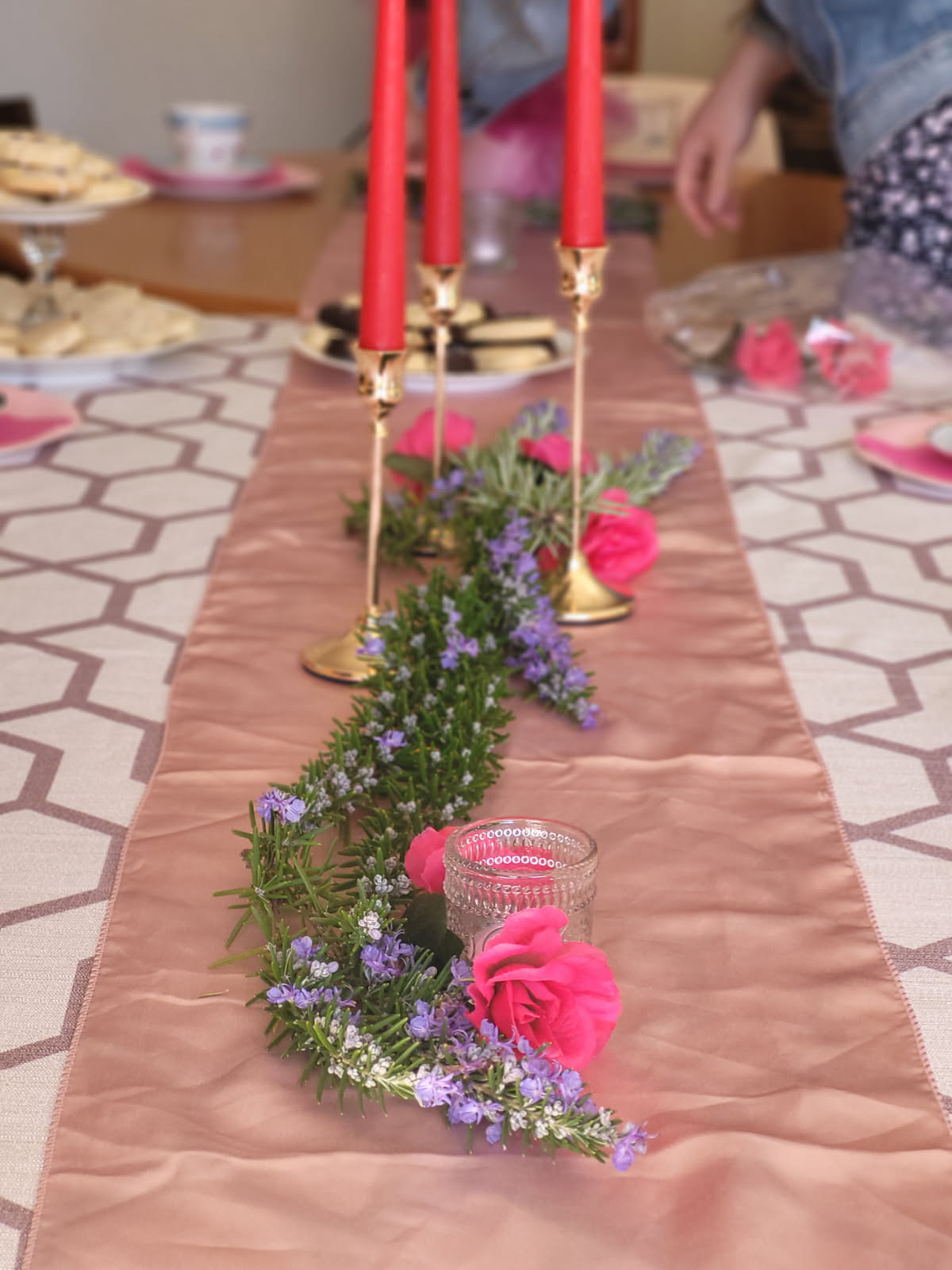 pink table runner with pink flowers and rosemary